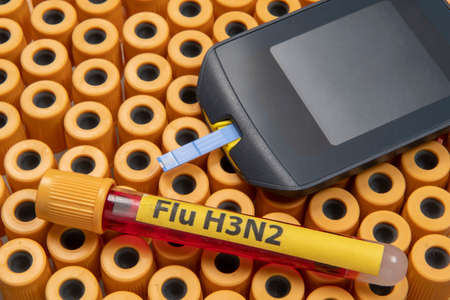 blood collection tubes labeled "Flu H3N2" symbolizing the flu epidemicの写真素材