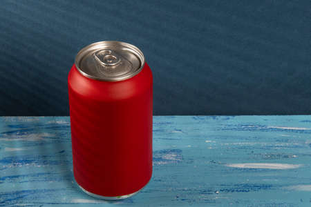 red soda can on blue background with shadowの写真素材