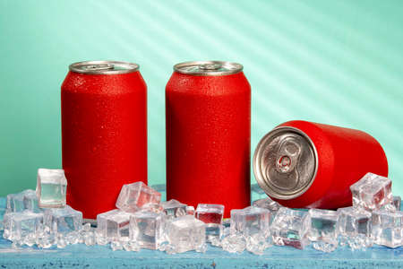 red soda can on blue background and with ice and coldの写真素材