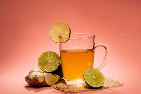 cup of tea with lemon, ginger and honey on a tableの写真素材