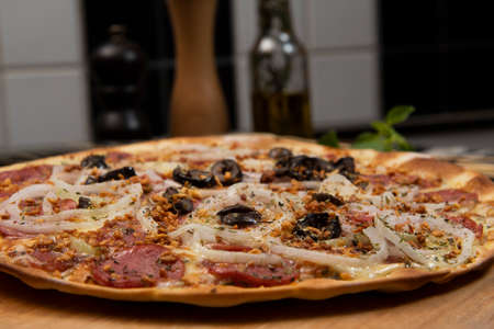 Brazilian pizza with pepperoni, cheese, onion and black olive , top viewの写真素材