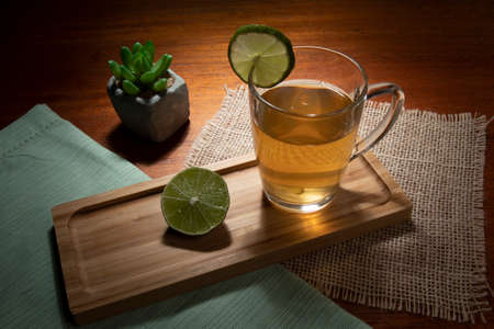 cup of tea with lemon, ginger and honey on a tableの写真素材