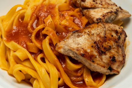 spaghetti dish with red sauce and chicken, brazilian cuisineの写真素材