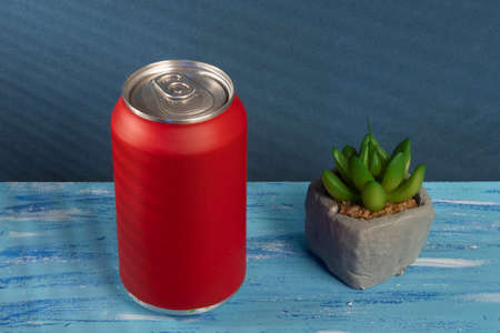 red soda can on blue background with shadowの写真素材