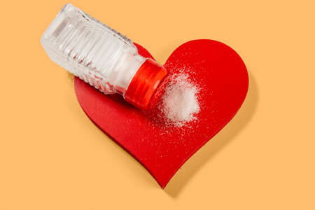 excess salt in the heart, shape of the organ with a salt shakerの写真素材