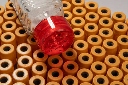 excess salt in the person's body represented by the salt shaker and blood collection tubesの写真素材