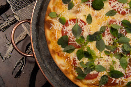 Brazilian pizza with pepperoni, cheese & arugula, top viewの写真素材