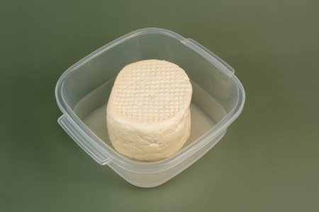 typical Brazilian Minas cheese from Minas Gerais in transparent plastic bowl