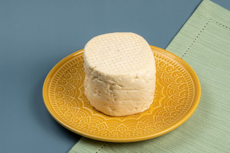 typical Brazilian Minas cheese from Minas Gerais on a yellow plate