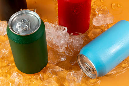 Several color aluminum can isolated on orange backgroundの写真素材