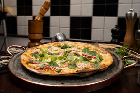Brazilian pizza with pepperoni, cheese & arugula, top viewの写真素材
