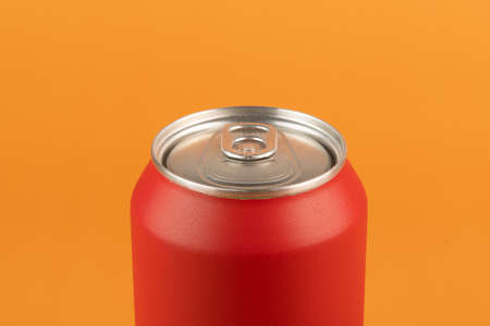 red aluminum can isolated on orange backgroundの写真素材