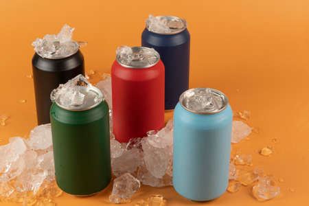 Several color aluminum can isolated on orange backgroundの写真素材