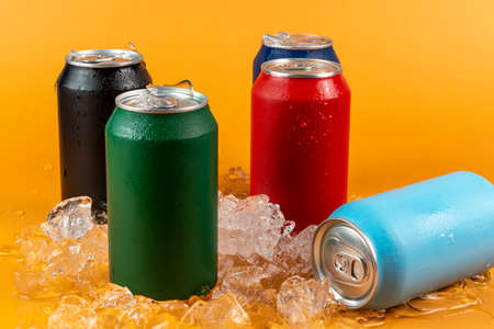 Several color aluminum can isolated on orange backgroundの写真素材