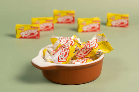 Peanut candy packaging (Pacoca Rockitas) inside a pot on a green background, consumed in June Partiesのeditorial素材