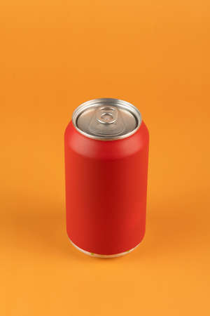 red aluminum can isolated on orange backgroundの写真素材