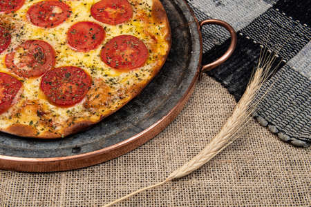 Neapolitan Brazilian pizza with mozzarella cheese and tomato slices with oregano, top viewの写真素材