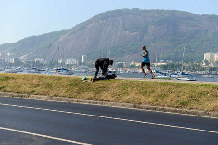 Rio de Janeiro, Brazil - March 13, 2022: policeman arresting and handcuffing a person in Botafogo coveのeditorial素材