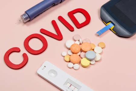 device to measure blood glucose, and the word written in pink background, top viewの写真素材