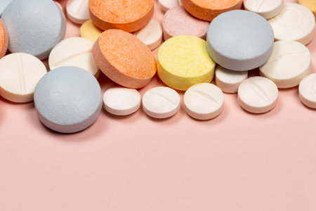 variation of coated tablets for treatment of diseases in a pink backgroundの写真素材