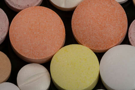 variation of coated tablets for treatment of diseases in a dark backgroundの写真素材