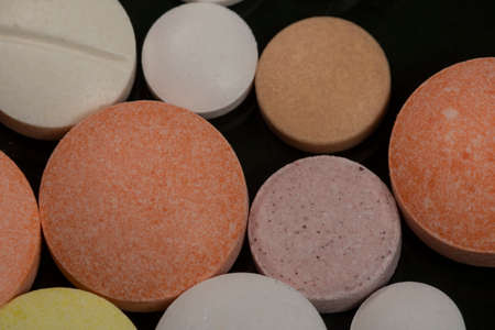 variation of coated tablets for treatment of diseases in a dark backgroundの写真素材