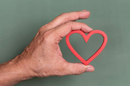 ungloved hand holding a heart shapeの写真素材