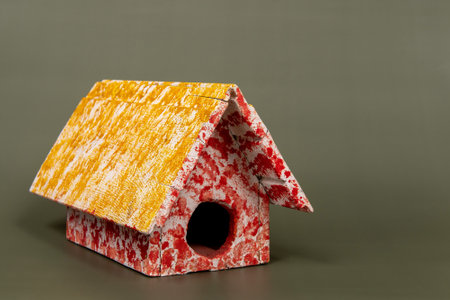wooden birdhouse isolated on green background, studio photo - copy spaceの写真素材