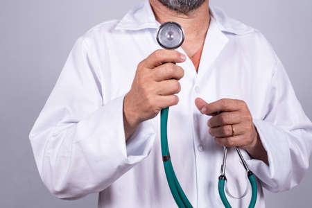 Senior attractive Brazilian doctor in a white coat, on the faceの写真素材