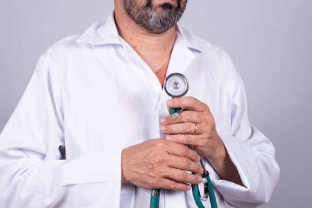 Senior attractive Brazilian doctor in a white coat, on the faceの写真素材