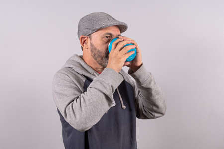 Portrait of happy senior in casual outfit and drinking sodaの写真素材