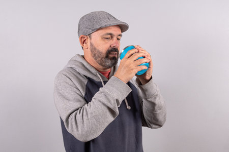 Portrait of happy senior in casual outfit and drinking sodaの写真素材