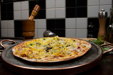 Brazilian Portuguese-style pizza with ham, egg, pepper, onion, mozzarellaの写真素材