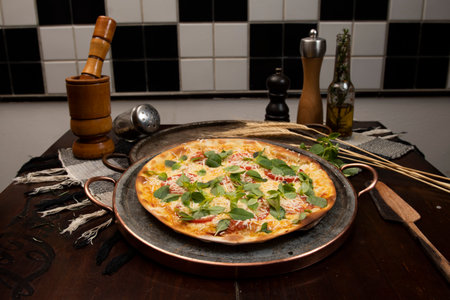 Brazilian pizza with pepperoni, cheese & arugula, top viewの写真素材