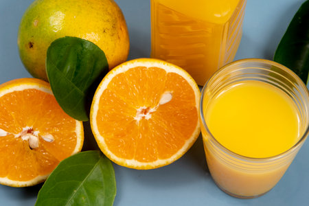Natural orange juice in the glass with bottle on the sideの写真素材