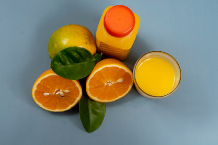 Natural orange juice in the glass with bottle on the sideの写真素材