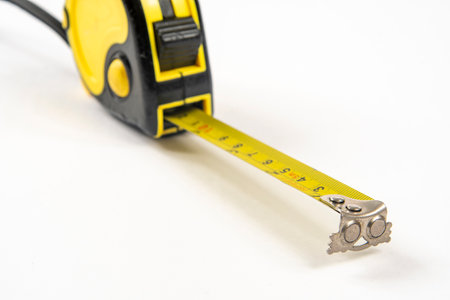 yellow tape measure to measure small spaces isolated in white backgroundの写真素材
