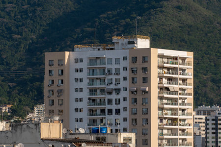 Rio, Brazil - July 15, 2022: view of apartment buildings in urban area with mountains in the background with greeneryのeditorial素材