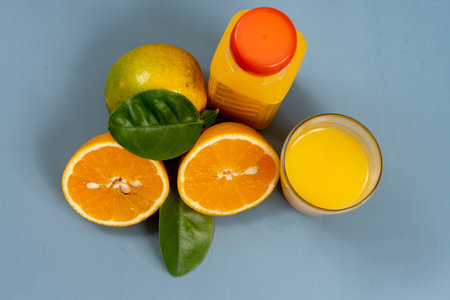Natural orange juice in the glass with bottle on the sideの写真素材
