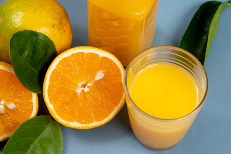 Natural orange juice in the glass with bottle on the sideの写真素材