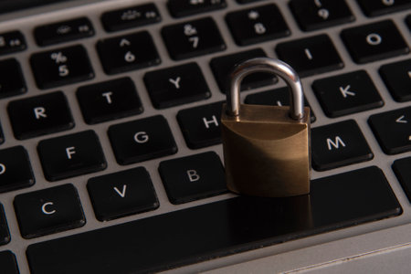 Internet and computer security represented by a closed padlock over a keyboardの写真素材