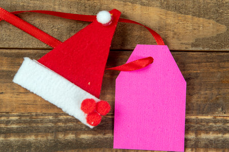 christmas decorative elements next to card with red ribbon and copy spaceの写真素材