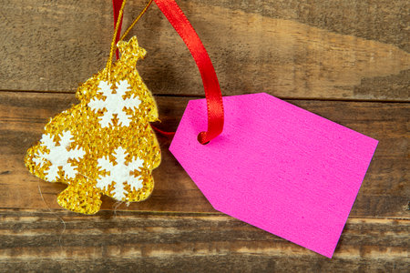 christmas decorative elements next to card with red ribbon and copy spaceの写真素材