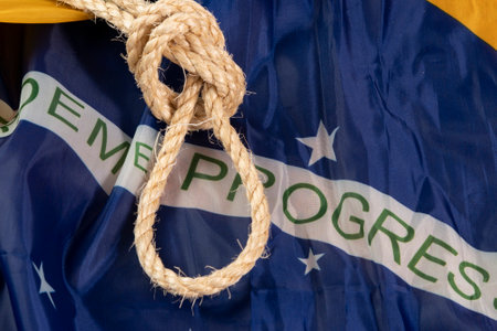 Rope with a noose over the Brazilian flag symbolizing slavery in the countryの写真素材