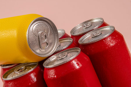Group of aluminum soda cans, chilled, frozen and with water drops