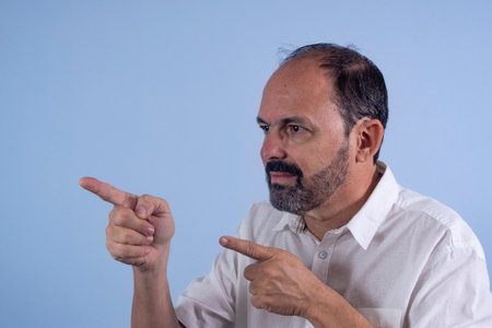 Portrait of 60 years old bearded man on blue background profileの写真素材