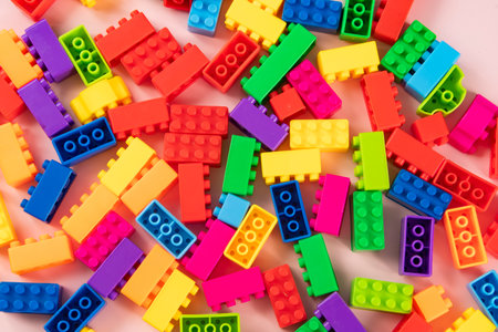Plastic building blocks on a pink background. Close-up.の写真素材