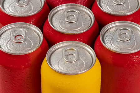 Closeup of red and yellow soda cans with water droplets.の写真素材
