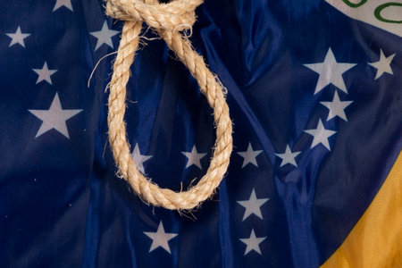 Rope with a noose over the Brazilian flag symbolizing slavery in the countryの写真素材