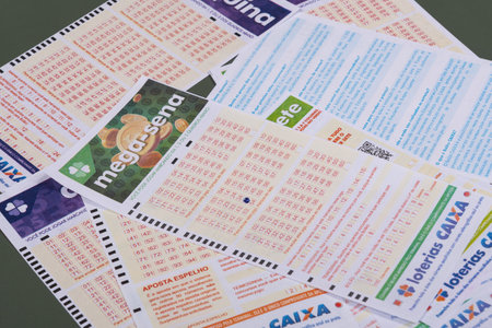 Rio, Brazil - July 20, 2022: person filling out Caixa Economica Federal lottery card, the only official betting method in Brazilのeditorial素材